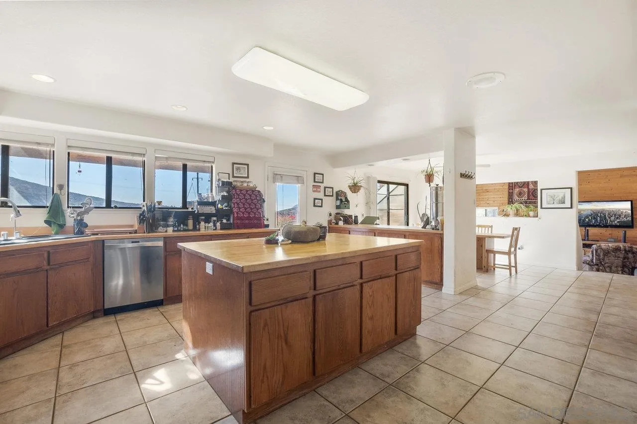 18995 Highway 94 Dulzura, CA 91917 - Photo 12 of 55 a kitchen with cabinets and chairs