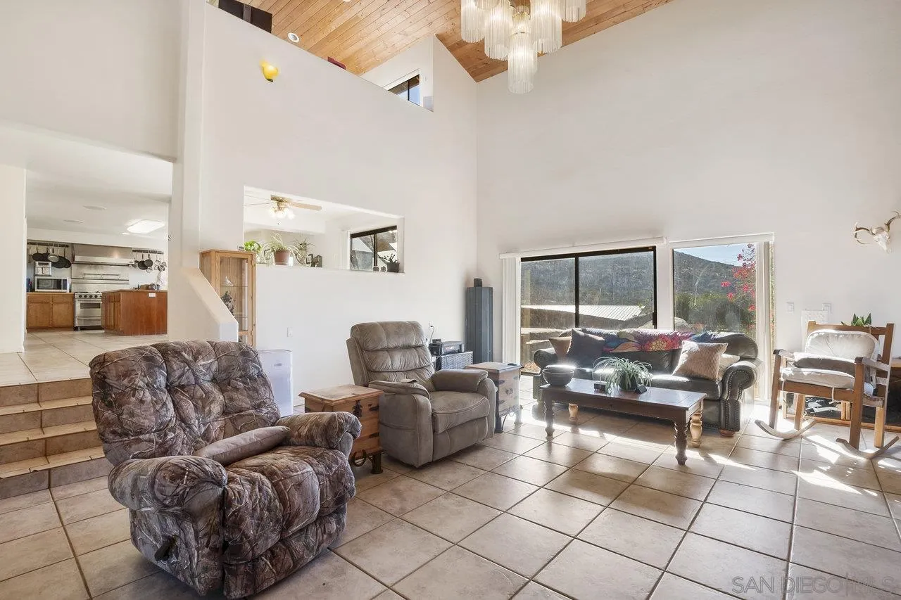 18995 Highway 94 Dulzura, CA 91917 - Photo 14 of 55 a living room with furniture and a chandelier