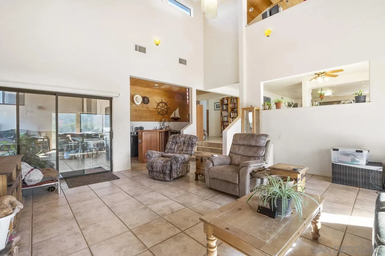 18995 Highway 94 Dulzura, CA 91917 - Photo 15 of 55 a living room with furniture and a floor to ceiling window