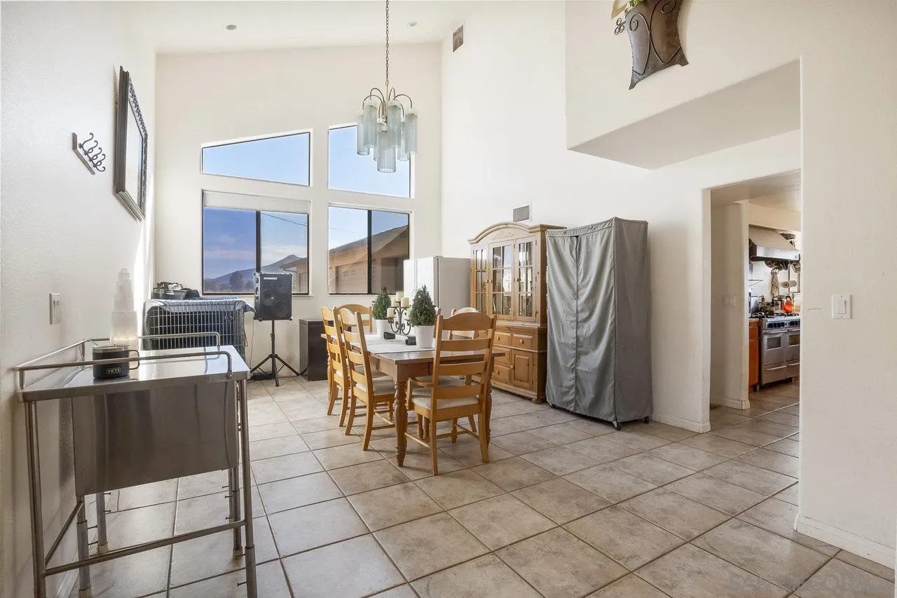 18995 Highway 94 Dulzura, CA 91917 - Photo 19 of 55 a dining room with furniture a chandelier and kitchen view
