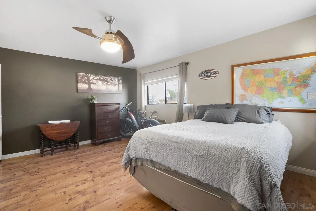 18995 Highway 94 Dulzura, CA 91917 - Photo 24 of 55 a spacious bedroom with a bed and a chandelier