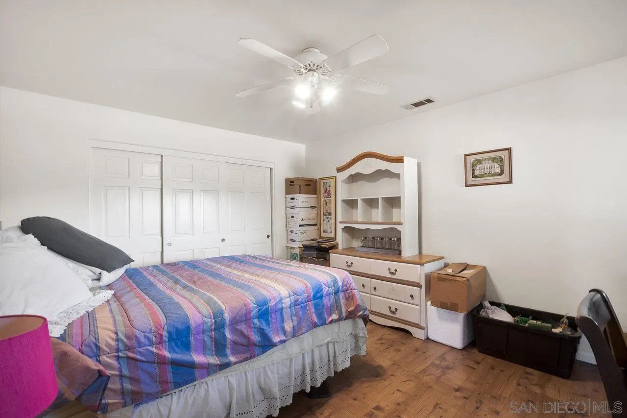 18995 Highway 94 Dulzura, CA 91917 - Photo 25 of 55 a bedroom with a bed and wooden floor