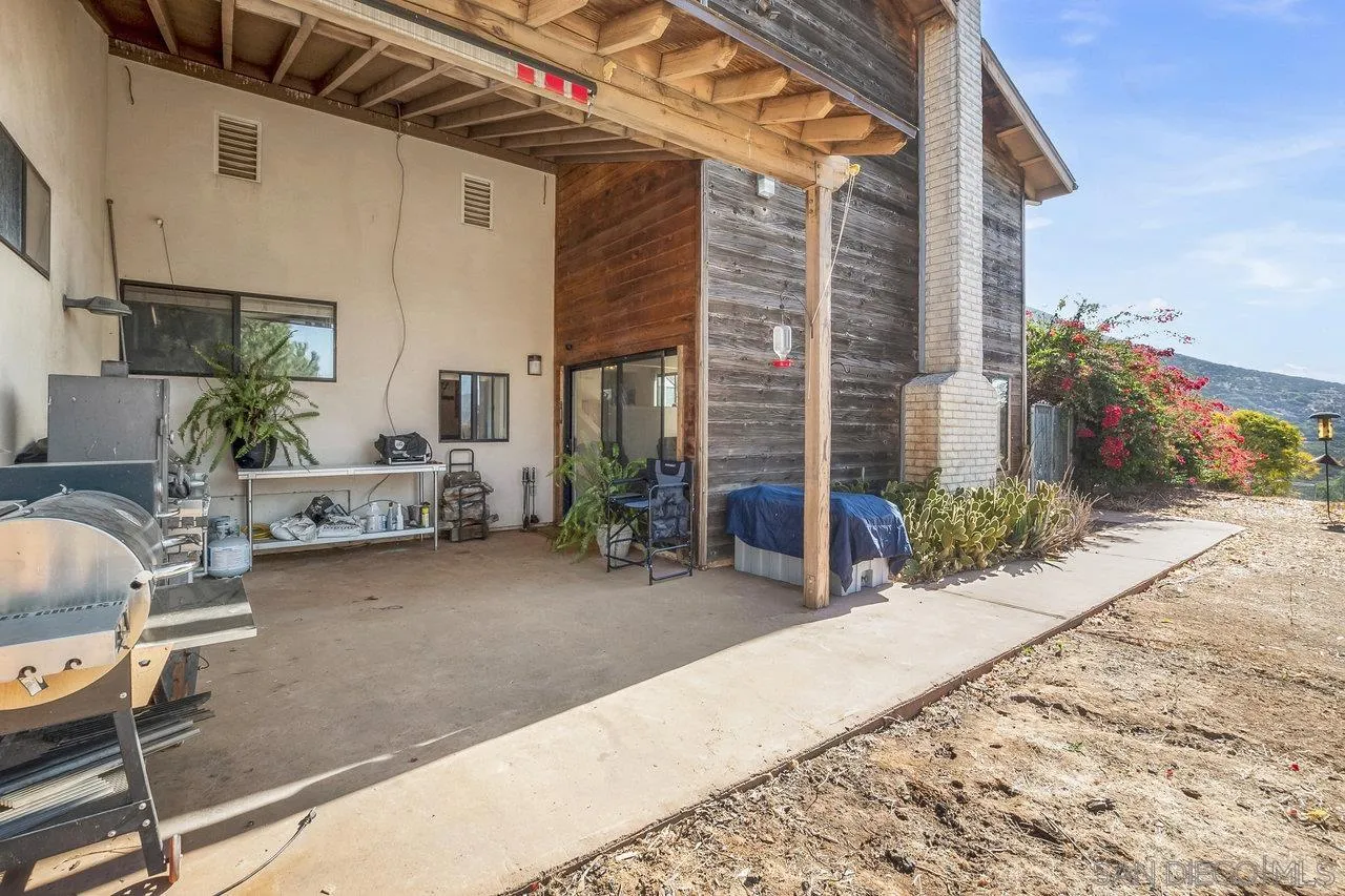 18995 Highway 94 Dulzura, CA 91917 - Photo 36 of 55 a backyard of a house with barbeque oven table and chairs