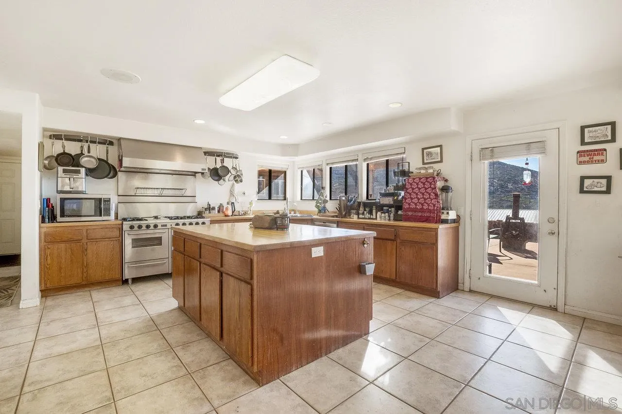 18995 Highway 94 Dulzura, CA 91917 - Photo 9 of 55 a kitchen with a sink a counter top space and appliances