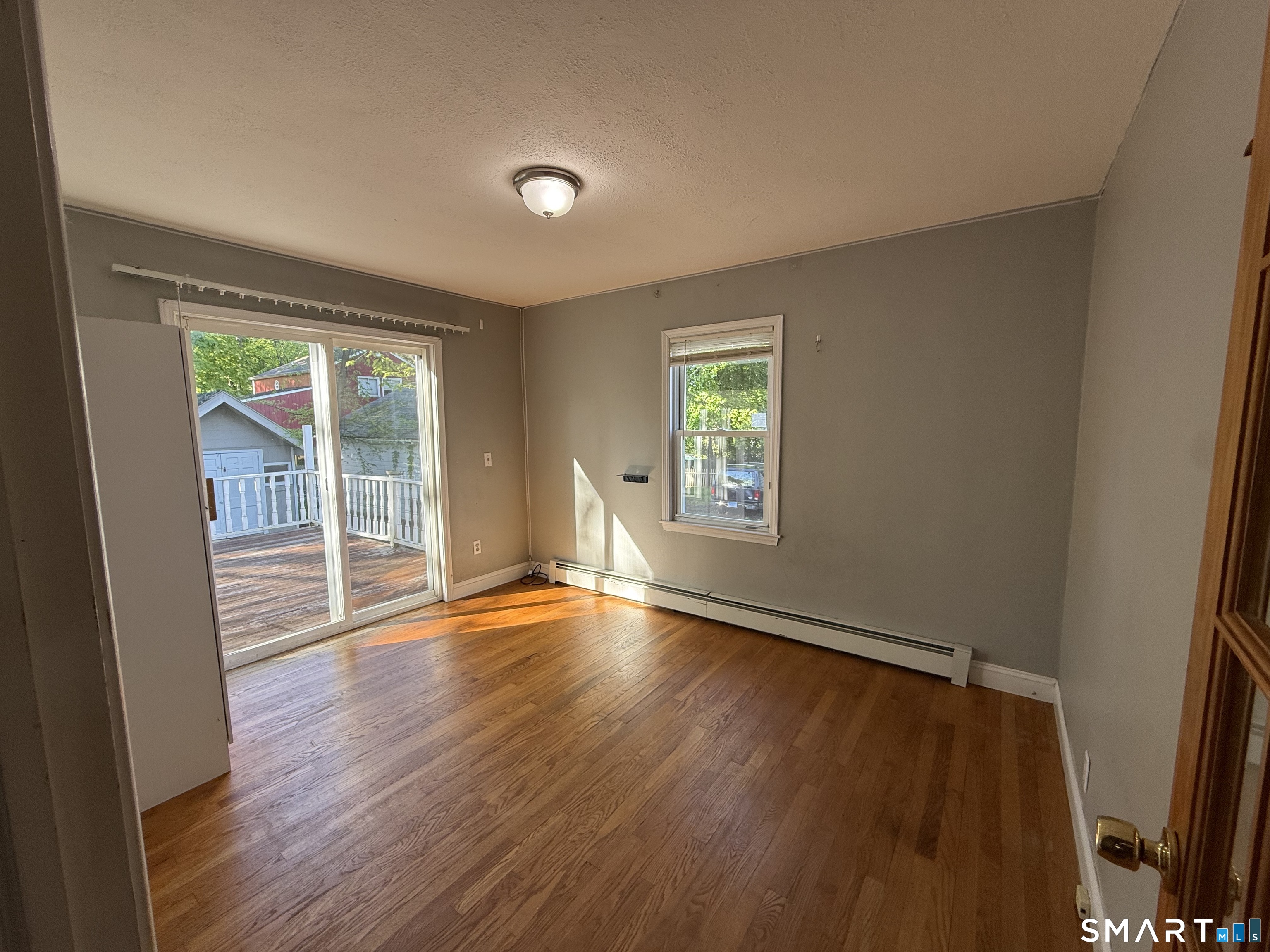 808 East Main Street Torrington, CT 06790 - Photo 26 of 40 an empty room with wooden floor and windows
