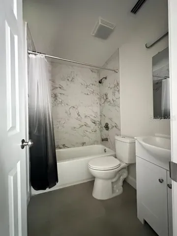 a view of a room with window and a ceiling fan