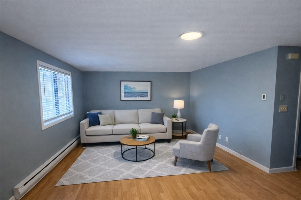 16 Cleveland Place, Unit 11 Gloucester, MA 01930 - Photo 2 of 8 a living room with furniture and a window