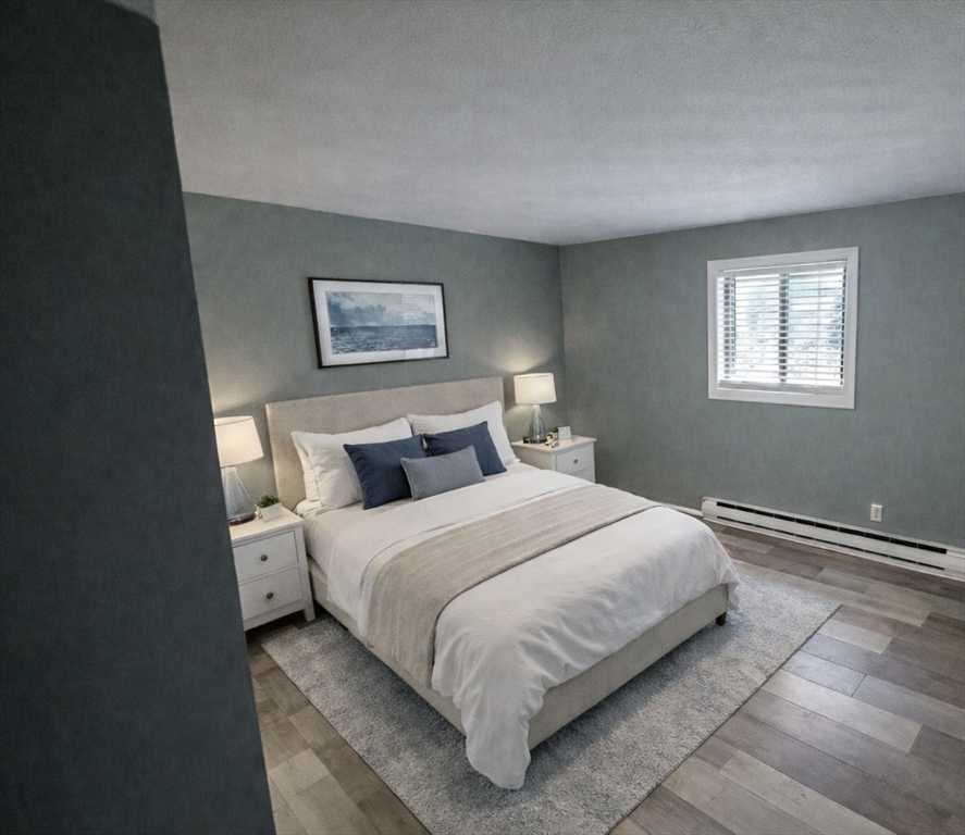 16 Cleveland Place, Unit 11 Gloucester, MA 01930 - Photo 3 of 8 a bedroom with bed and window
