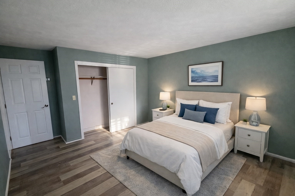 16 Cleveland Place, Unit 11 Gloucester, MA 01930 - Photo 4 of 8 a bedroom with a bed and a painting on the wall