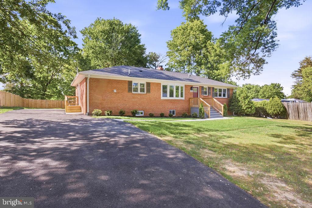 6620 Napoli Road Temple Hills, MD 20748 - Photo 3 of 38 a front view of house with yard and trees in the background