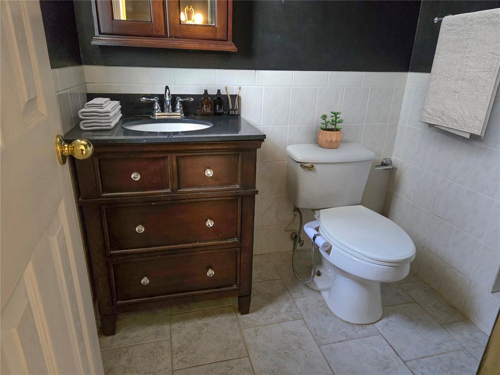 19 Spring Dr Place Ocala, FL 34472 - Photo 21 of 29 a bathroom with a toilet a sink and mirror
