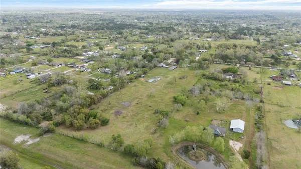 a view of a city with lush green forest