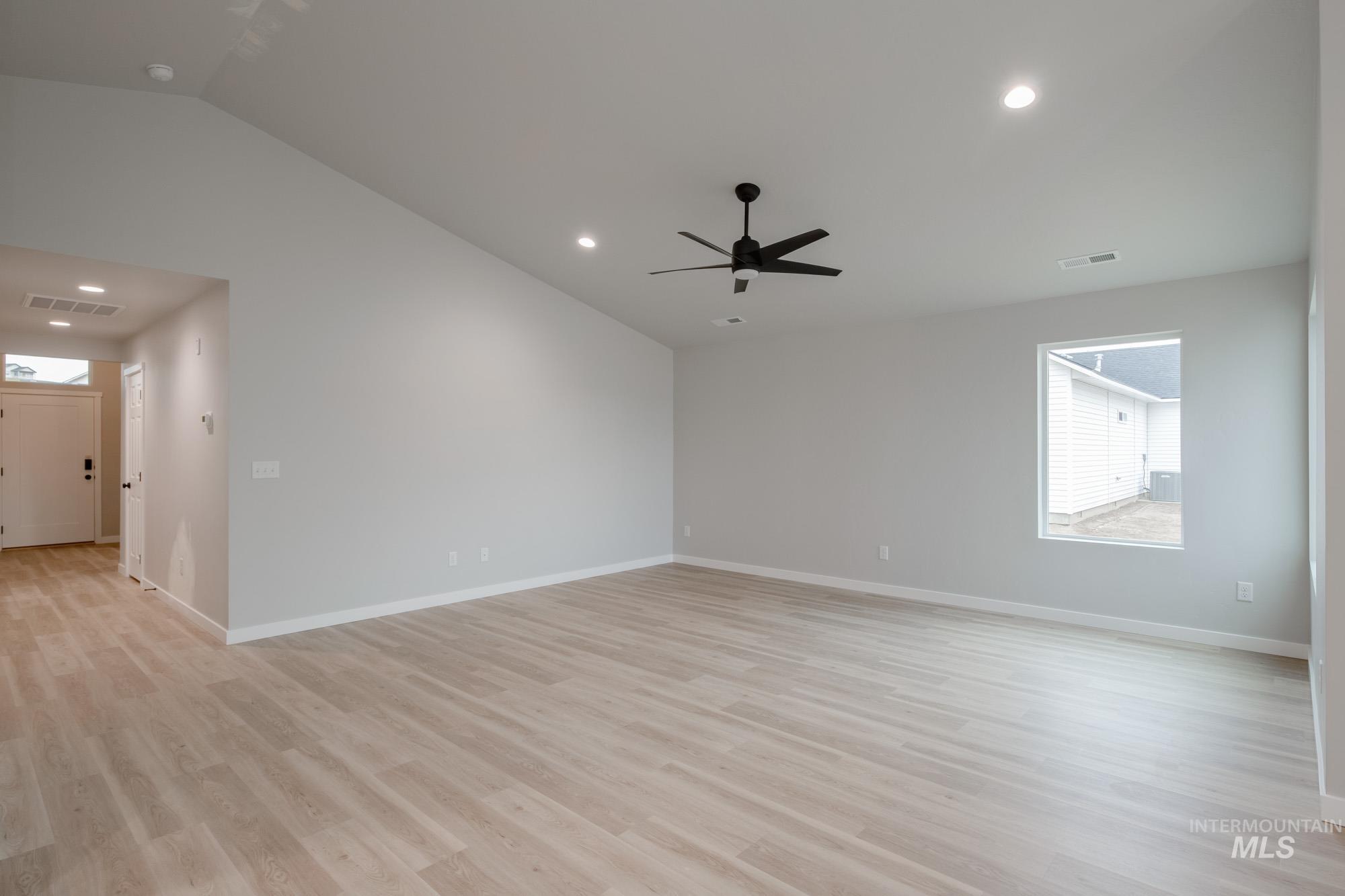 1631 Long Pond Street Middleton, ID 83644 - Photo 12 of 22 Spare room featuring lofted ceiling, healthy amount of natural light, light wood-type flooring, and recessed lighting