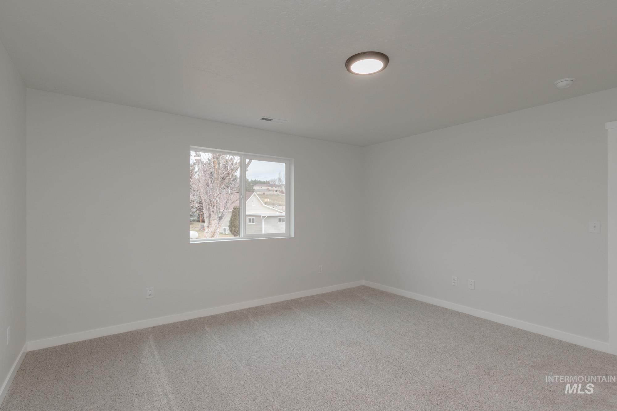 1631 Long Pond Street Middleton, ID 83644 - Photo 14 of 22 Empty room featuring light carpet and baseboards
