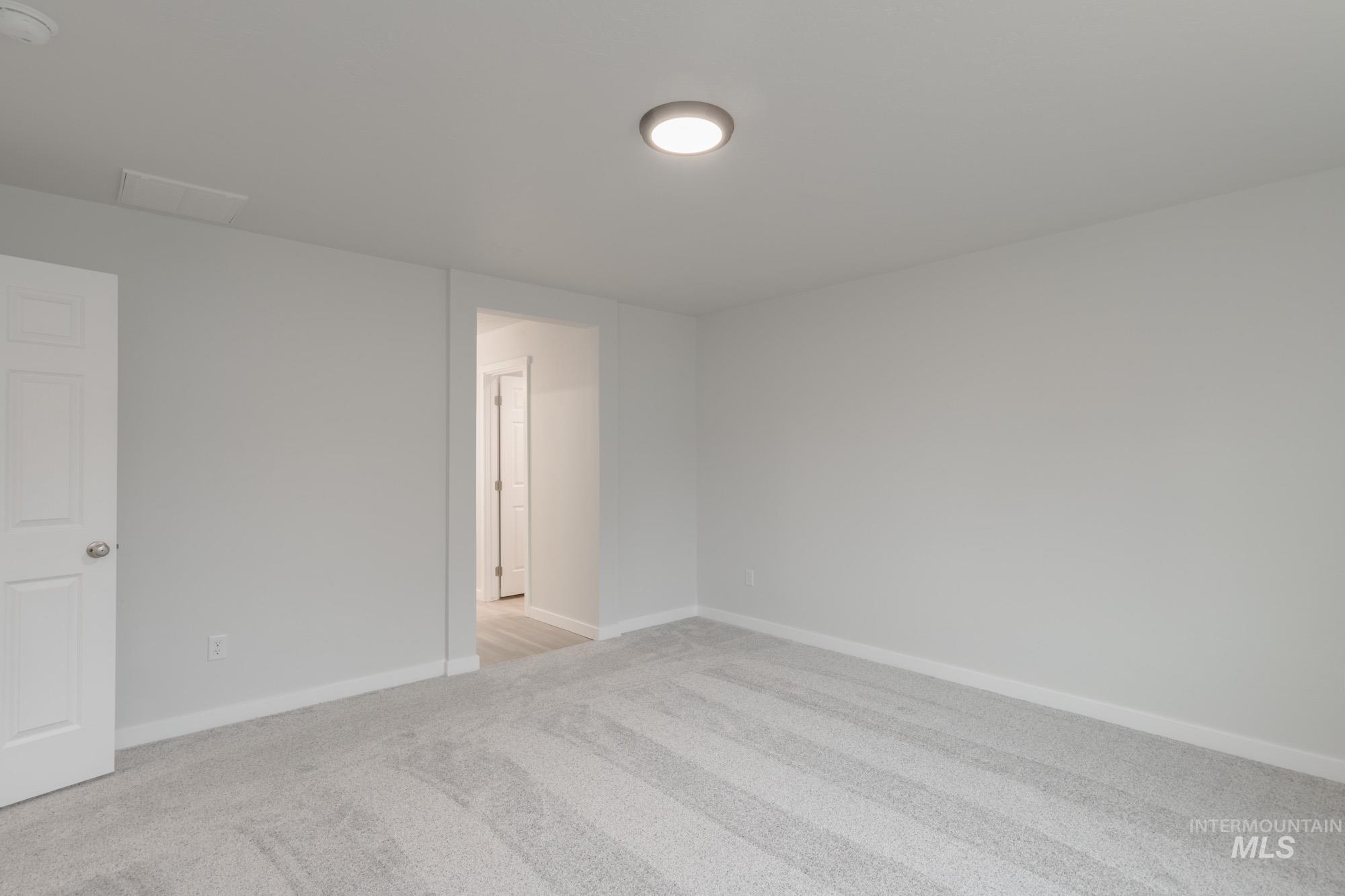 1631 Long Pond Street Middleton, ID 83644 - Photo 15 of 22 Empty room featuring light colored carpet and baseboards
