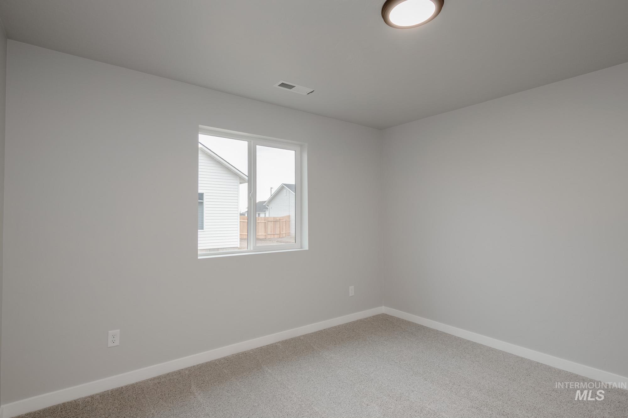 1631 Long Pond Street Middleton, ID 83644 - Photo 17 of 22 Carpeted spare room featuring baseboards