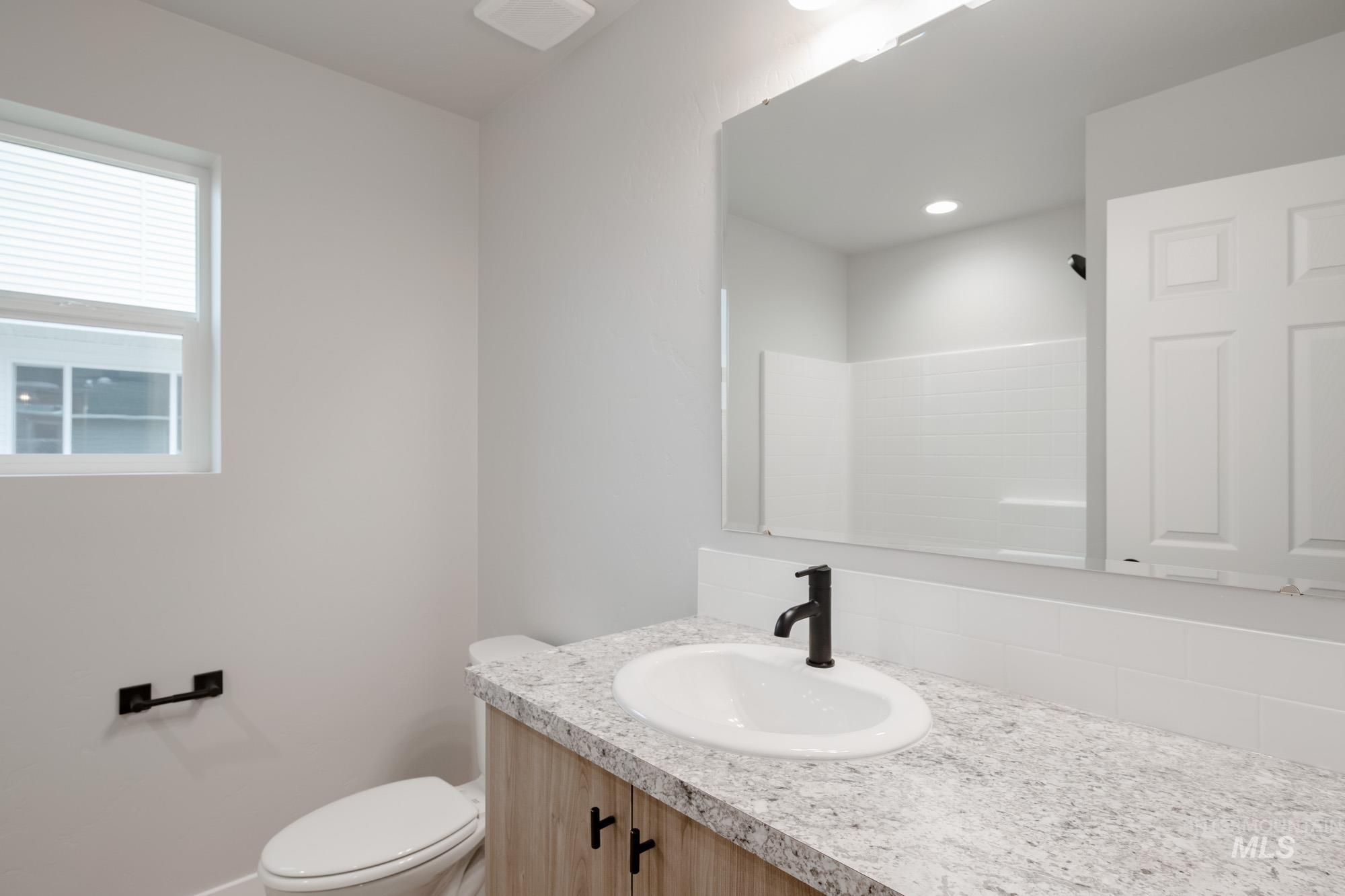 1631 Long Pond Street Middleton, ID 83644 - Photo 18 of 22 Bathroom with vanity, a shower, and backsplash