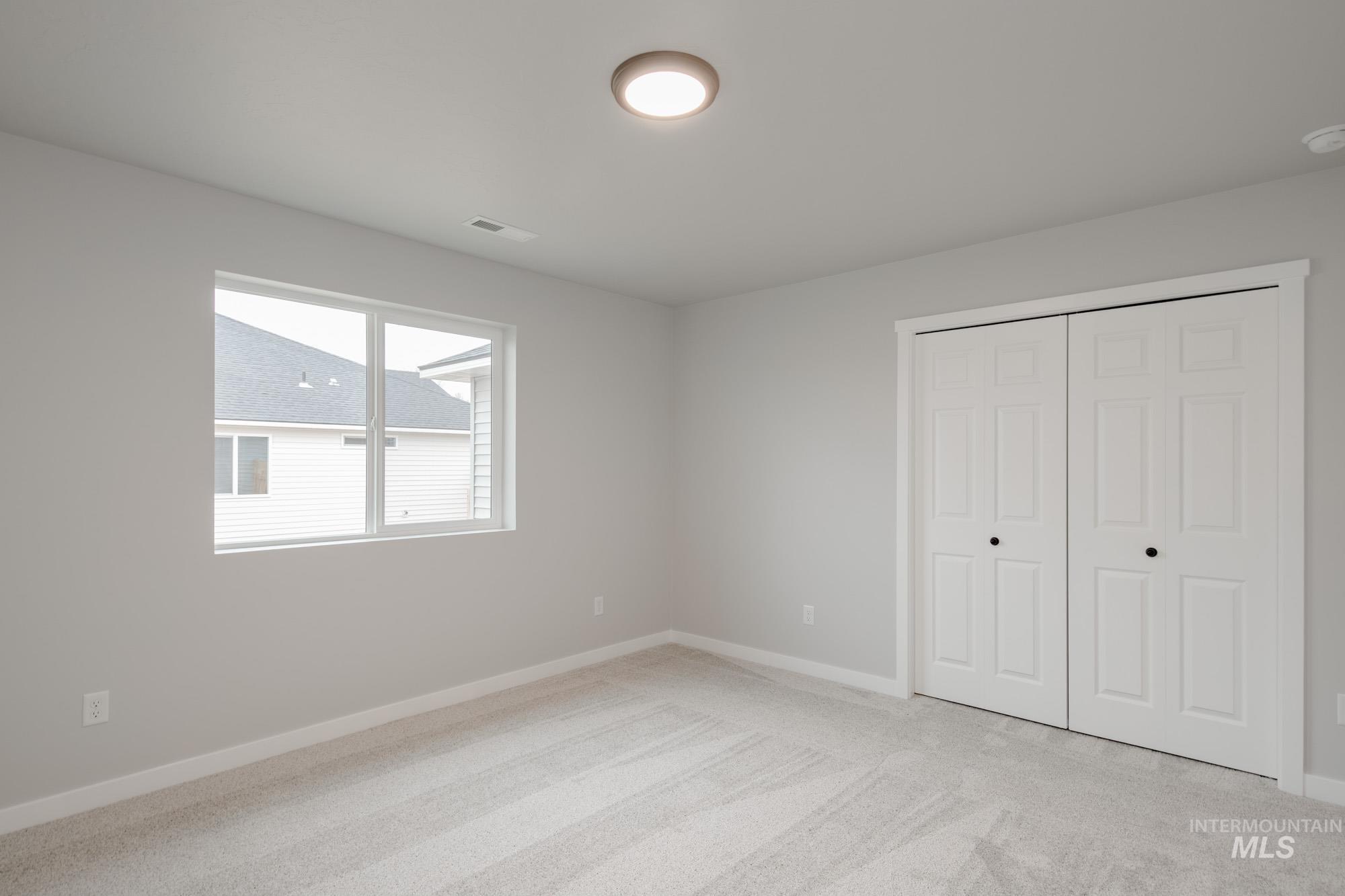 1631 Long Pond Street Middleton, ID 83644 - Photo 19 of 22 Unfurnished bedroom featuring light carpet and a closet