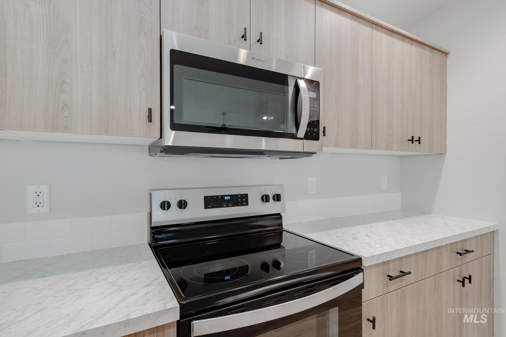 1631 Long Pond Street Middleton, ID 83644 - Photo 6 of 22 Kitchen featuring light brown cabinets, appliances with stainless steel finishes, light countertops, and modern cabinets