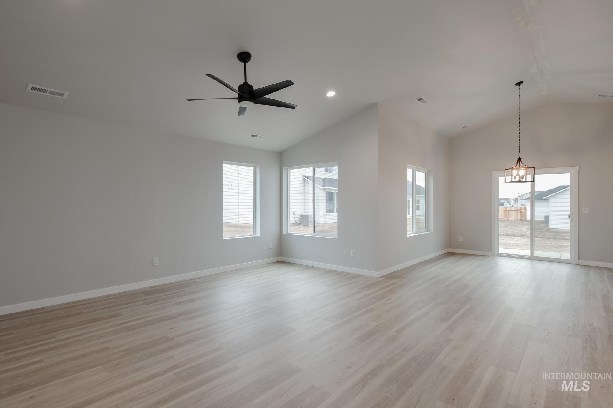 1631 Long Pond Street Middleton, ID 83644 - Photo 10 of 22 Spare room featuring lofted ceiling, light wood-style flooring, plenty of natural light, a ceiling fan, and recessed lighting