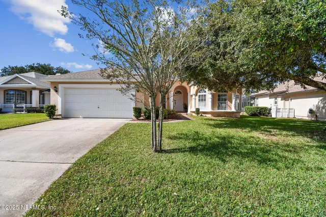 a view of house with a yard