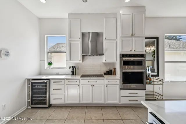 a kitchen with stainless steel appliances a stove sink and microwave