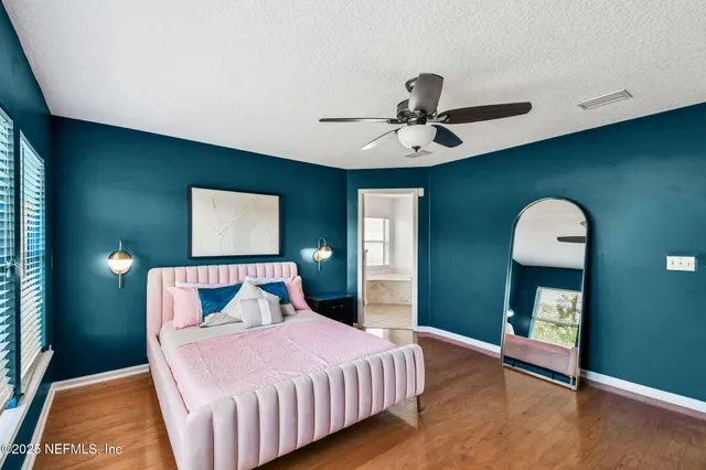 a bedroom with a bed and a chandelier
