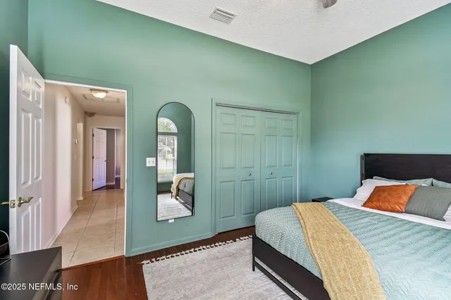 a bedroom with a bed and mirror