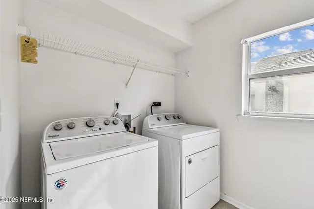 a hallway with white cabinets and wooden floor