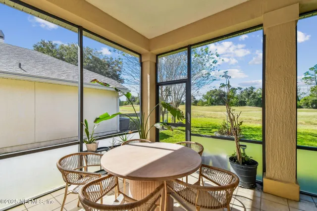a balcony view with a large window and furniture