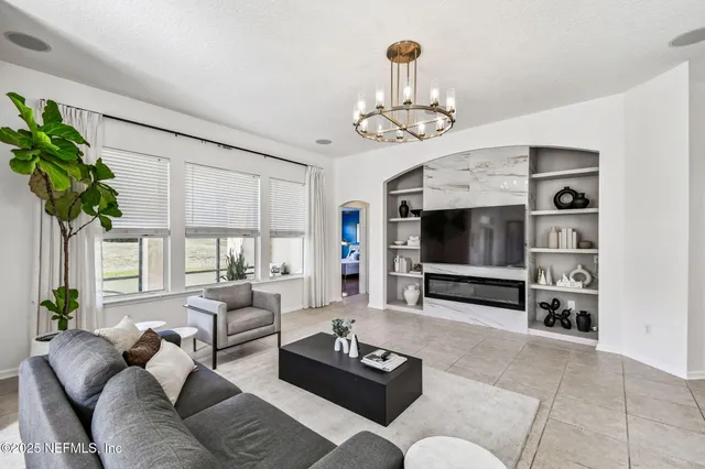 a living room with furniture a flat screen tv and a fireplace