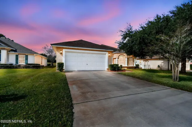 an aerial view of a house with a garden and lake view