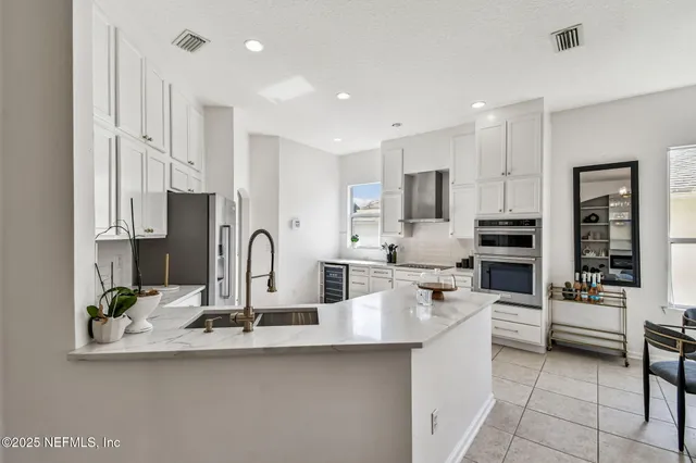 a kitchen with stainless steel appliances kitchen island granite countertop a sink and cabinets