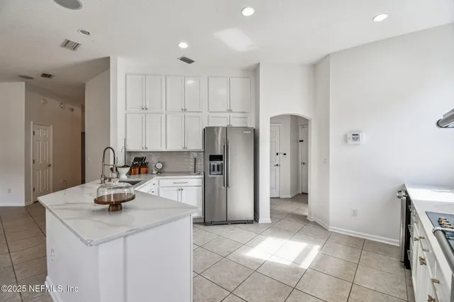 a kitchen with refrigerator and cabinets