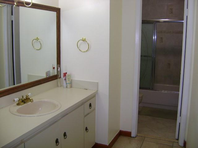 1950 Southwest 121st Court, Unit 240 Miami, FL 33175 - Photo 17 of 27 a bathroom with a sink and a mirror