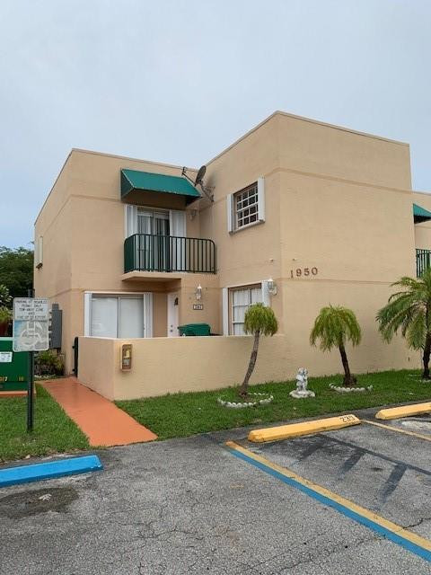 1950 Southwest 121st Court, Unit 240 Miami, FL 33175 - Photo 22 of 27 a front view of a house with garden
