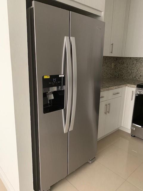 1950 Southwest 121st Court, Unit 240 Miami, FL 33175 - Photo 8 of 27 a kitchen with a refrigerator and white cabinets