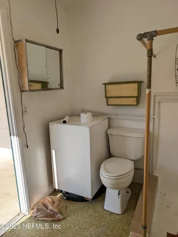 a white toilet sitting next to a bathroom sink