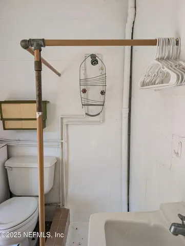 a bathroom with a toilet and a shower