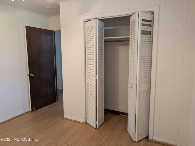 an empty room with closet and a bathroom
