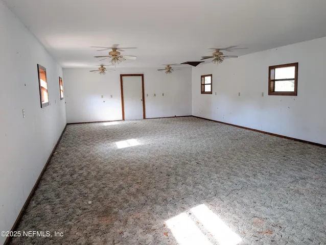 a view of empty room with ceiling fan