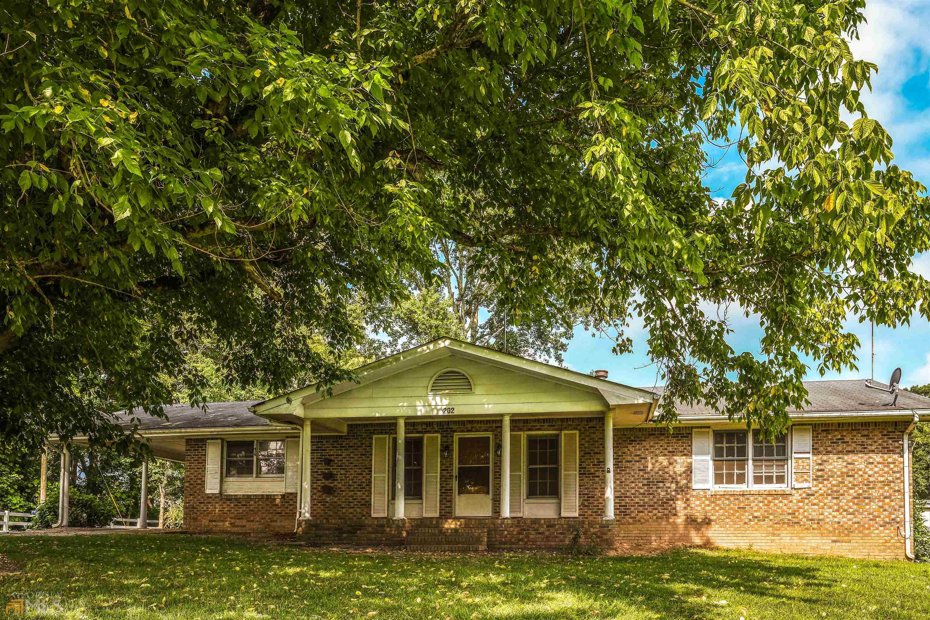 202 Rockmart Road Bremen, GA 30110 - Photo 1 of 1 a front view of a house with a garden
