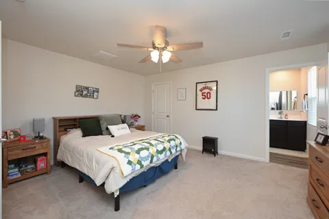 a bedroom with a bed and a chandelier