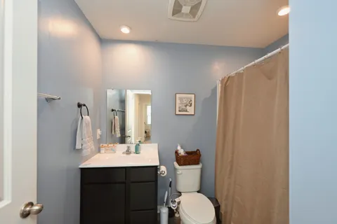 a bathroom with a toilet sink shower and mirror