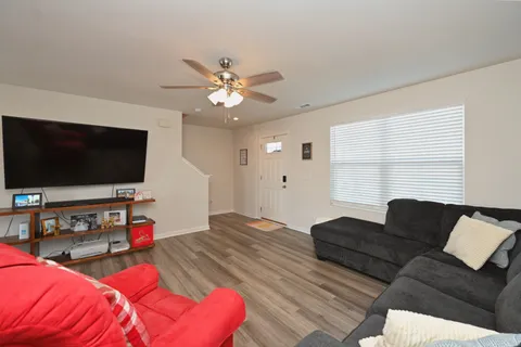 a living room with furniture and a flat screen tv