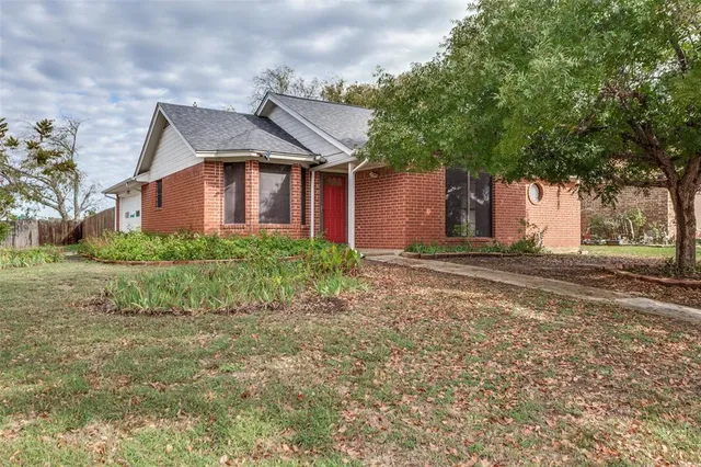 a front view of house with yard and trees