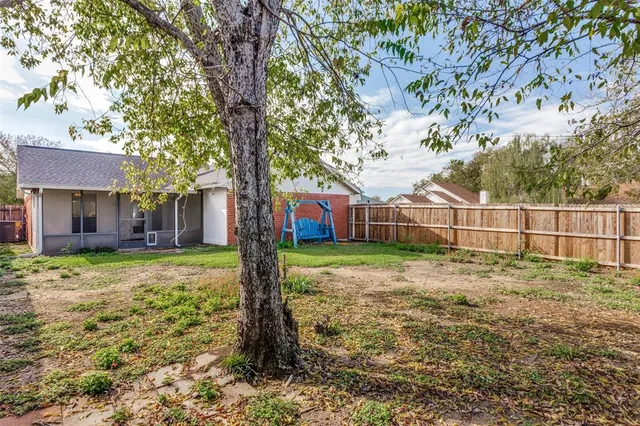 a view of a brick house with a yard