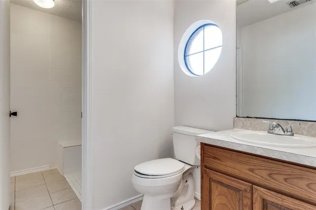 a bathroom with a toilet sink vanity and mirror