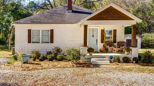 a front view of a house with garden