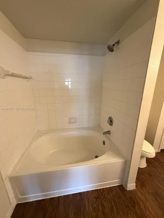 a bathroom with a bathtub and toilet